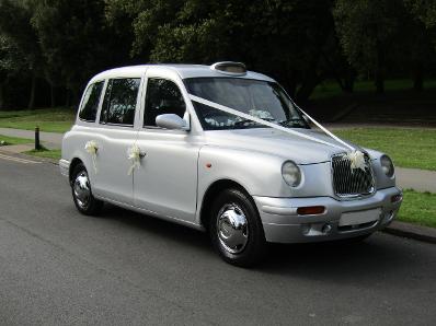 Taxi photo booth in silver with white ribbon and bows